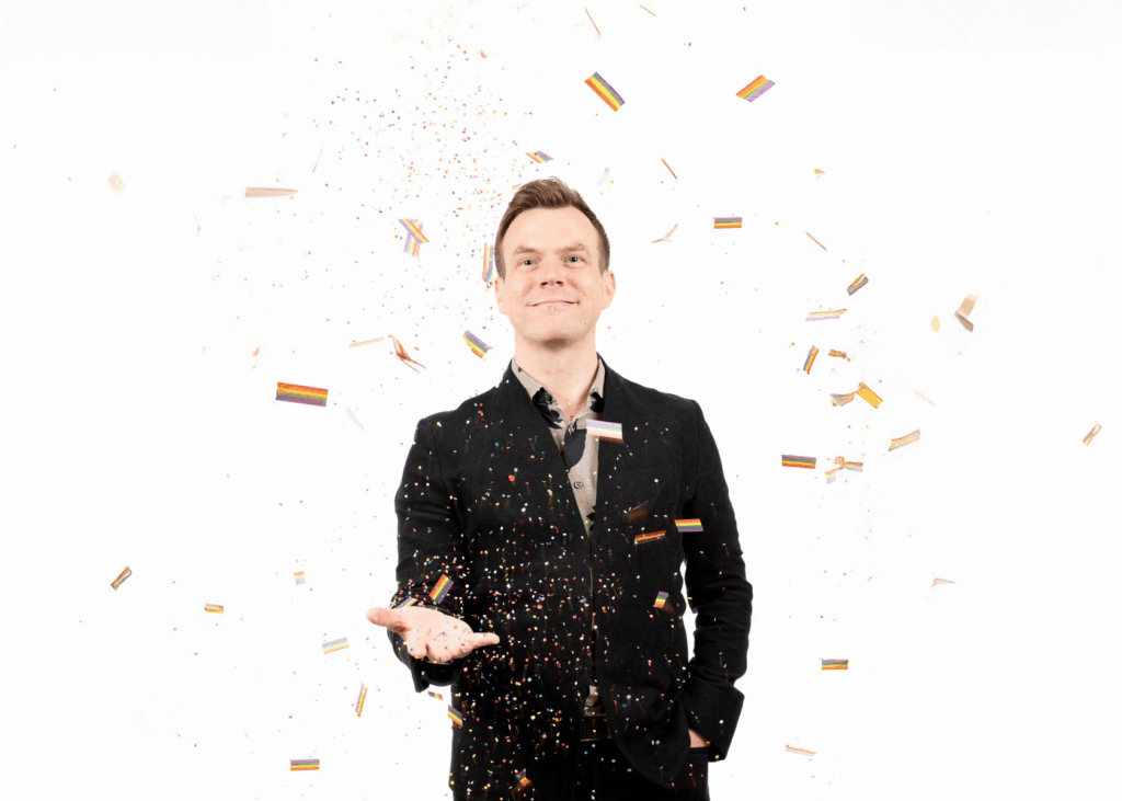 Jake Stensberg joyfully tossing colorful confetti