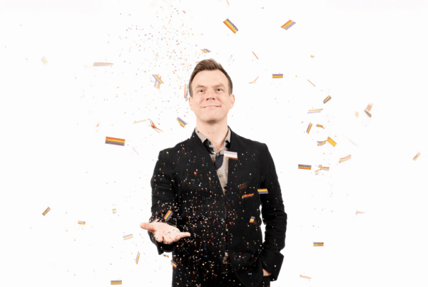 Jake Stensberg joyfully tossing colorful confetti