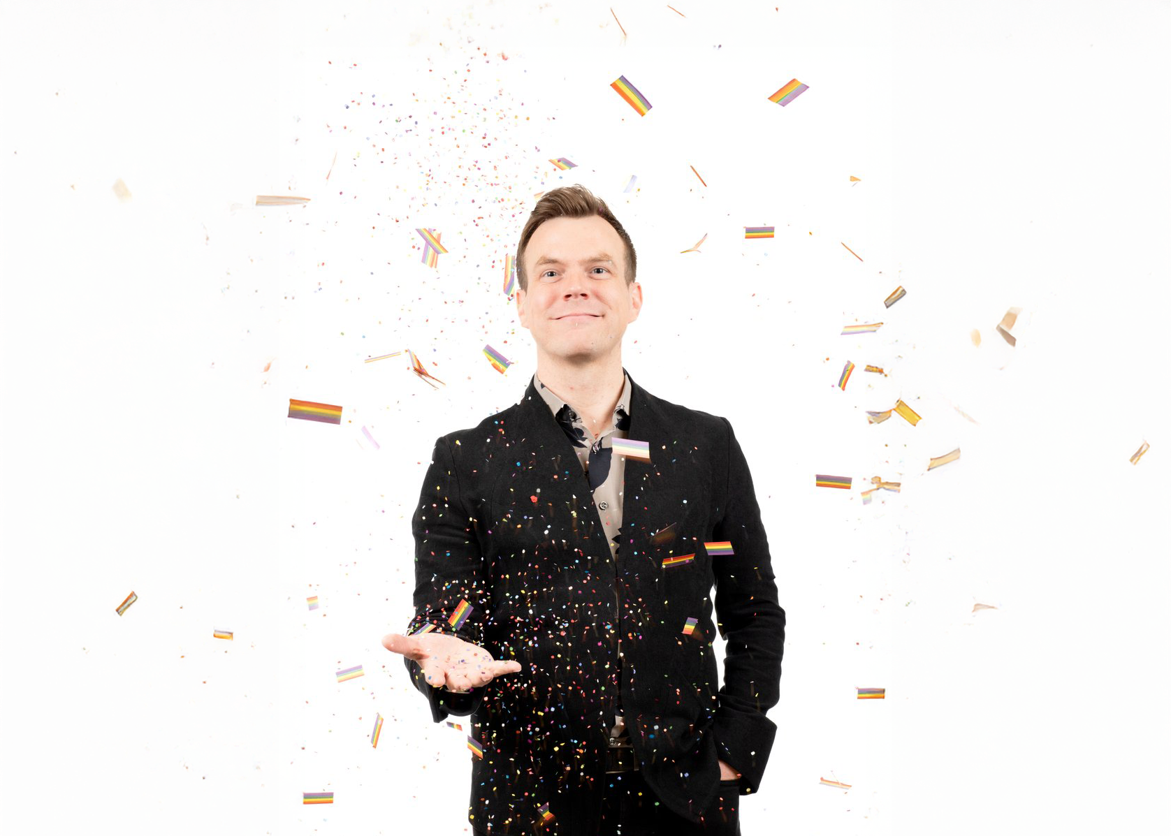 Jake Stensberg joyfully tossing colorful confetti